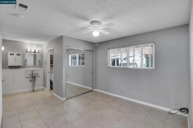 unfurnished bedroom with a textured ceiling and ceiling fan