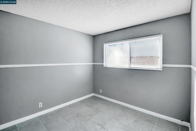 spare room with a textured ceiling