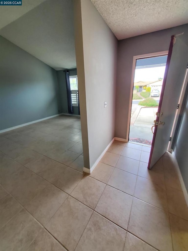 tiled foyer featuring a textured ceiling