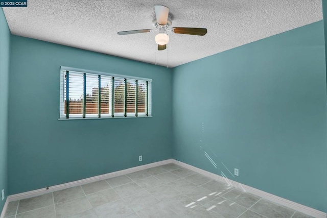 spare room with a textured ceiling, ceiling fan, and light tile patterned flooring