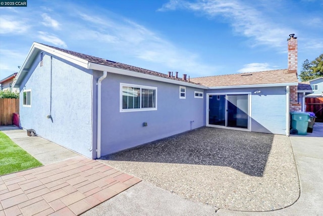 back of property with a patio