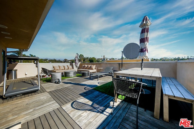 wooden terrace featuring outdoor lounge area