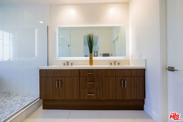 bathroom featuring tile patterned flooring, vanity, and walk in shower