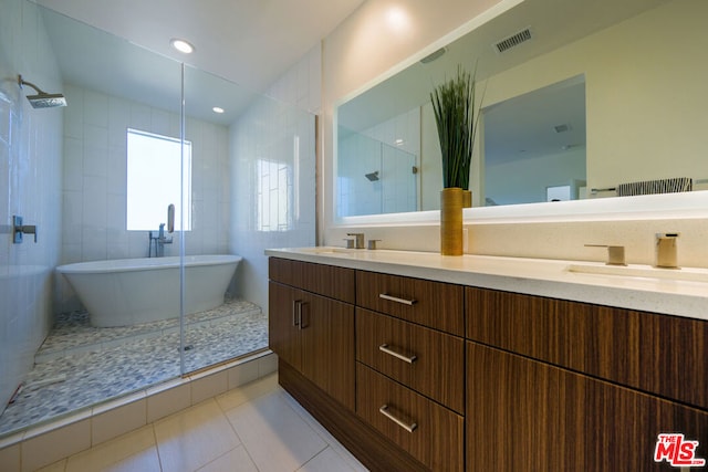 bathroom featuring tile patterned flooring, vanity, tile walls, and plus walk in shower