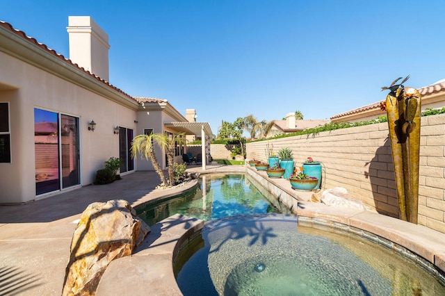 view of swimming pool featuring an in ground hot tub, a pergola, and a patio area