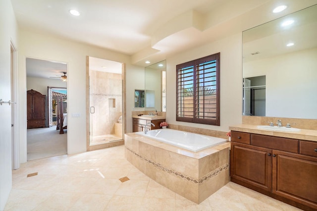 bathroom with ceiling fan, vanity, shower with separate bathtub, and tile patterned flooring