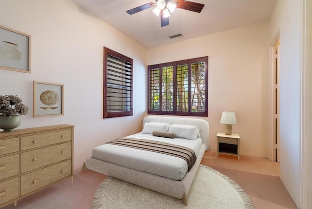 bedroom featuring light carpet and ceiling fan