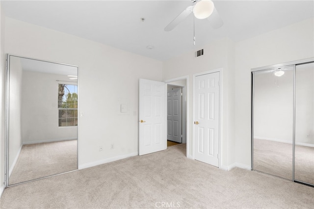 unfurnished bedroom with light colored carpet and ceiling fan