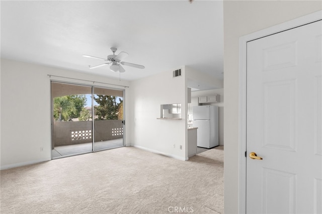 carpeted empty room featuring ceiling fan