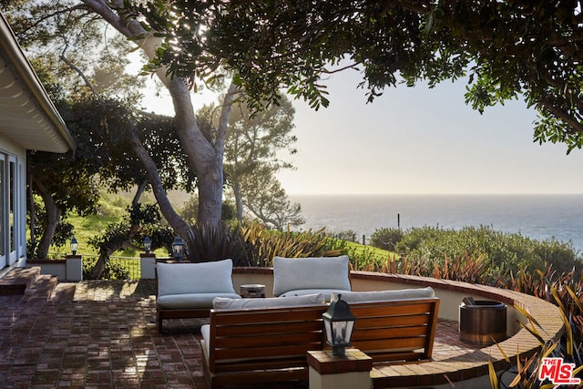 deck with an outdoor hangout area, a patio, and a water view