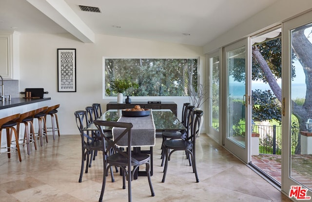 dining space with vaulted ceiling