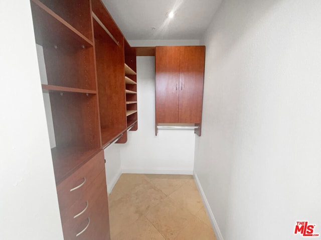 spacious closet featuring light tile patterned flooring