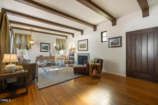 living room with hardwood / wood-style flooring, beam ceiling, and a wealth of natural light