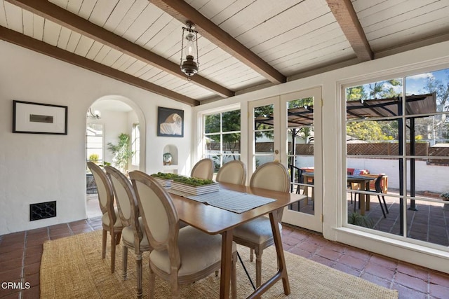 dining room featuring lofted ceiling with beams and wood ceiling