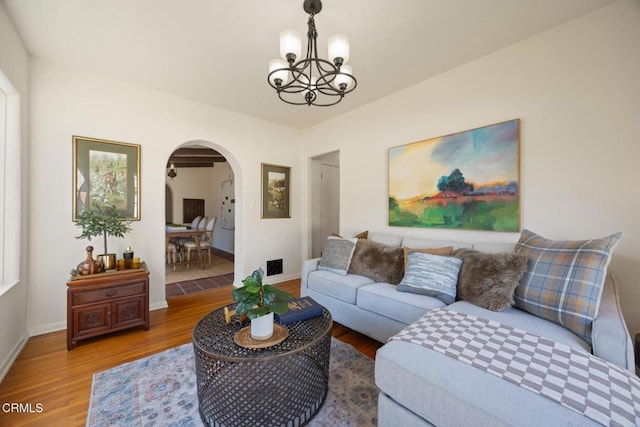 living room featuring an inviting chandelier and hardwood / wood-style floors