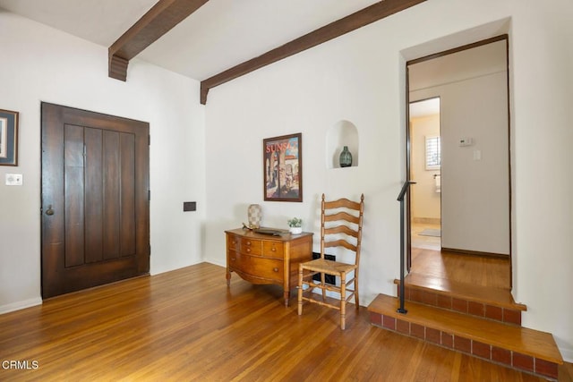 foyer featuring hardwood / wood-style flooring and beam ceiling