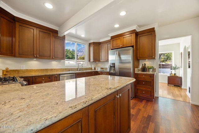 kitchen featuring sink, appliances with stainless steel finishes, light stone countertops, dark hardwood / wood-style flooring, and beamed ceiling