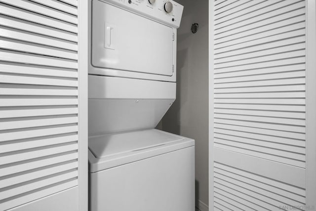 laundry area featuring stacked washer / dryer