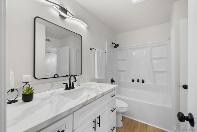 full bathroom with vanity, wood-type flooring,  shower combination, and toilet