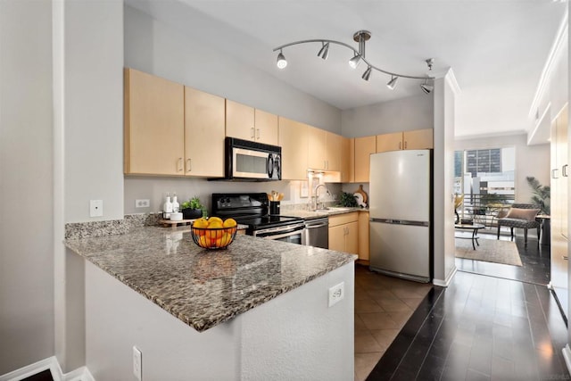 kitchen featuring light brown cabinetry, sink, dark stone countertops, kitchen peninsula, and stainless steel appliances