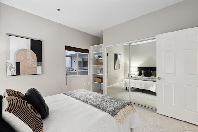 bedroom featuring a closet and light carpet