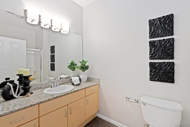 bathroom with vanity, tile patterned floors, toilet, and walk in shower