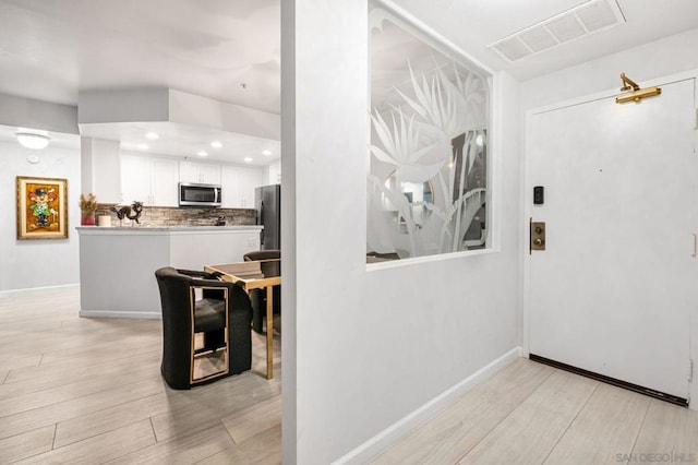 hall with light hardwood / wood-style floors