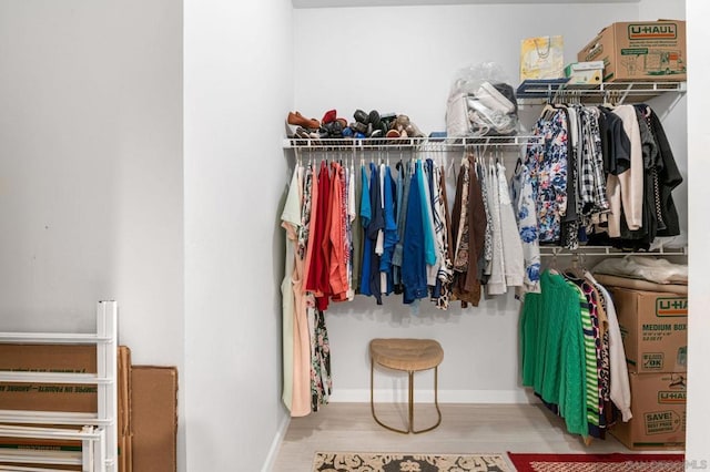 walk in closet featuring light hardwood / wood-style flooring