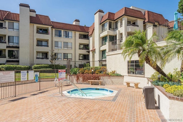 view of swimming pool with a patio and a community hot tub