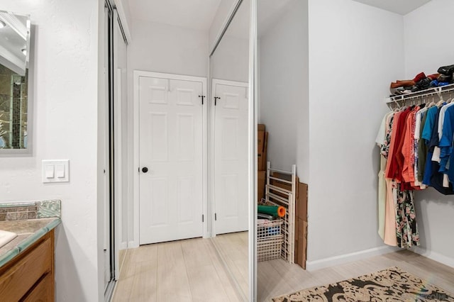 bathroom with vanity and hardwood / wood-style flooring