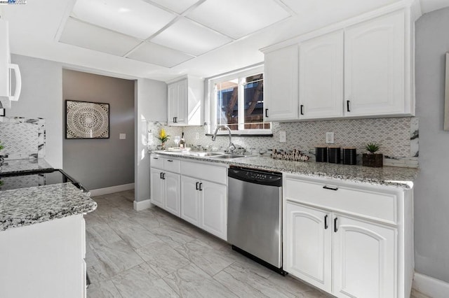 kitchen featuring sink, dishwasher, white cabinetry, light stone counters, and tasteful backsplash