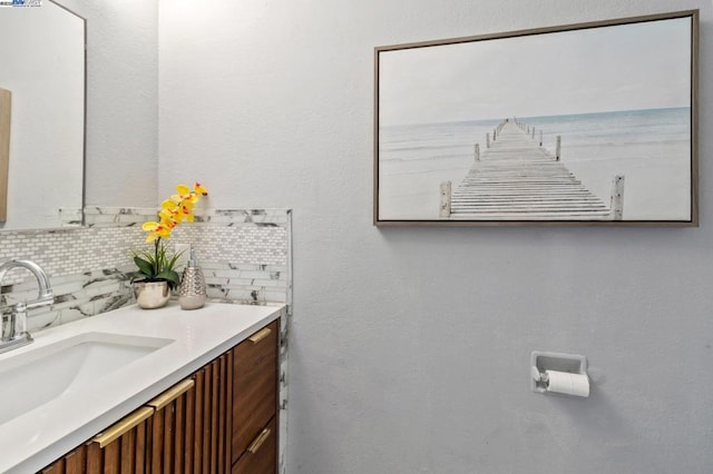 bathroom with tasteful backsplash and vanity