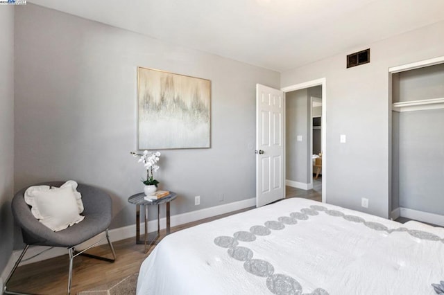 bedroom with hardwood / wood-style floors and a closet