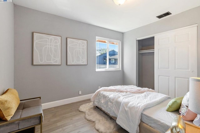 bedroom featuring light hardwood / wood-style floors and a closet