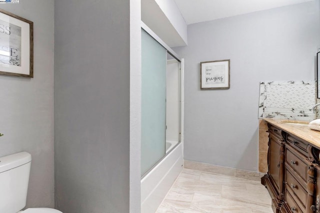 full bathroom with vanity, tasteful backsplash, combined bath / shower with glass door, and toilet