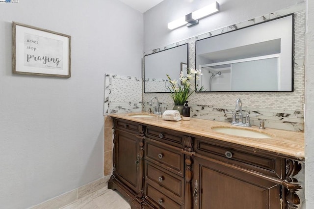 bathroom featuring tasteful backsplash, vanity, and a shower