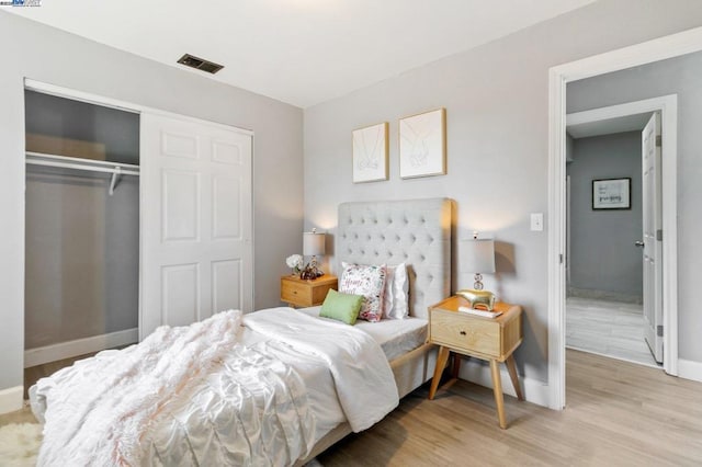 bedroom featuring light hardwood / wood-style flooring and a closet