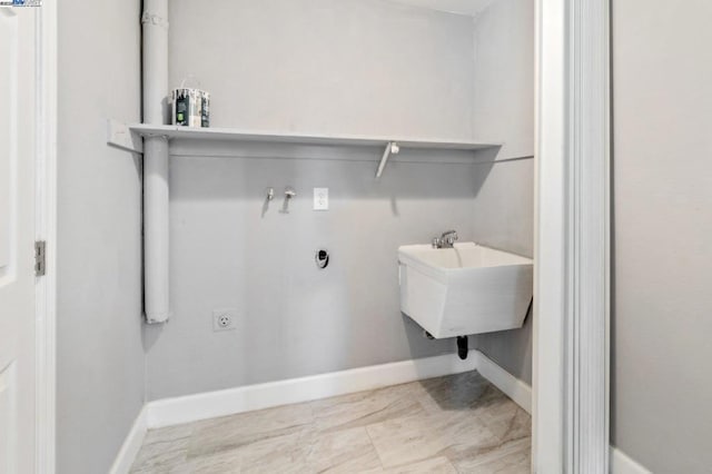 clothes washing area featuring sink and hookup for an electric dryer