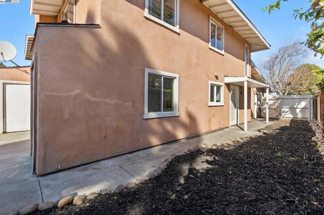 view of side of property with a patio area