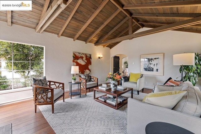 living room featuring hardwood / wood-style flooring, lofted ceiling with beams, and wooden ceiling