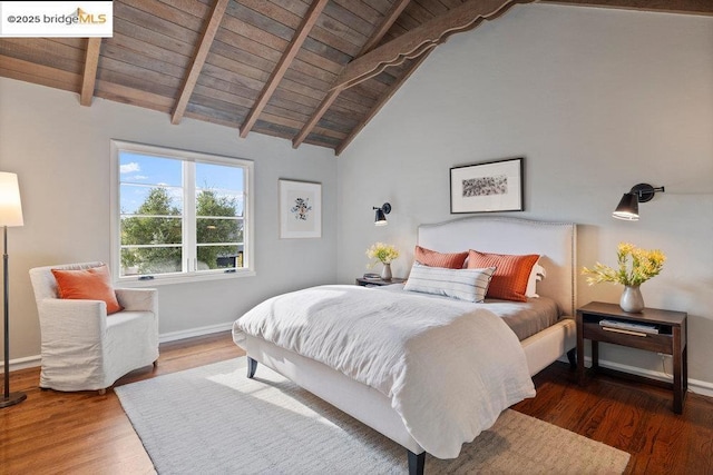 bedroom with lofted ceiling with beams, dark hardwood / wood-style floors, and wooden ceiling