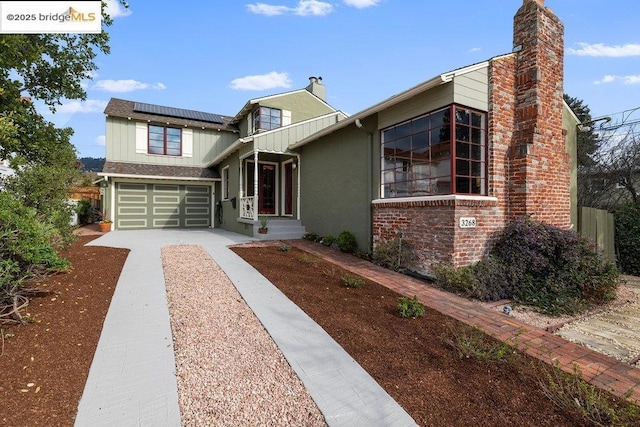 view of front of house with a garage and solar panels