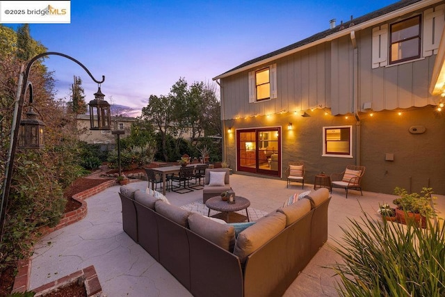 patio terrace at dusk featuring an outdoor hangout area