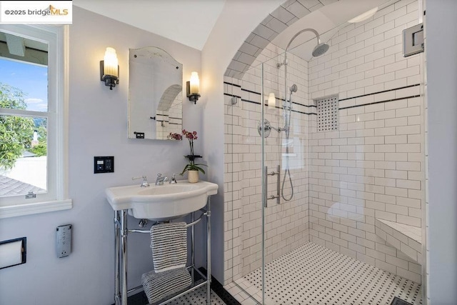 bathroom with vanity and a shower with door