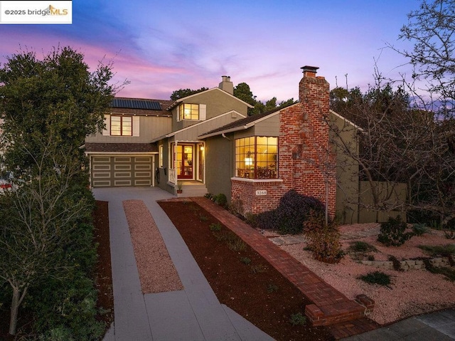 view of front of house with a garage and solar panels