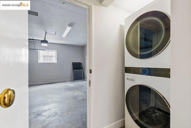 clothes washing area with stacked washer / drying machine