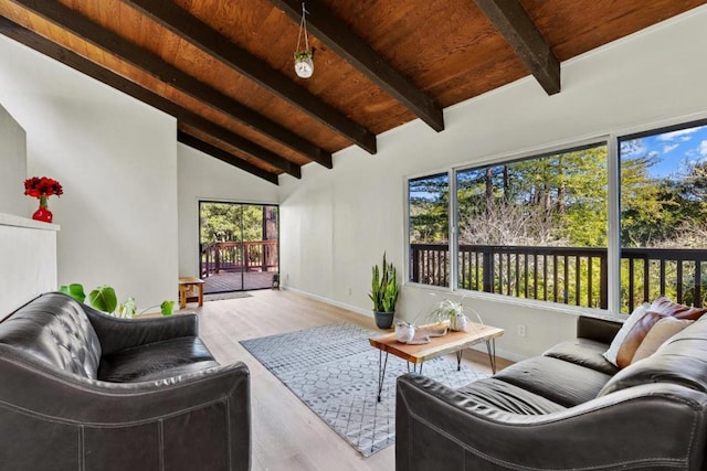 living room featuring vaulted ceiling with beams, light hardwood / wood-style floors, and wooden ceiling