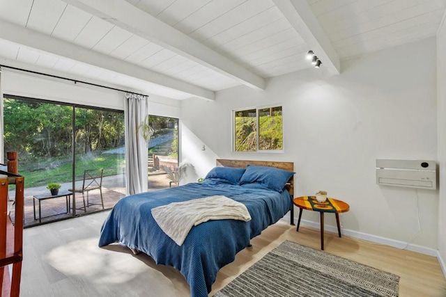 bedroom with beamed ceiling, access to outside, and light hardwood / wood-style floors