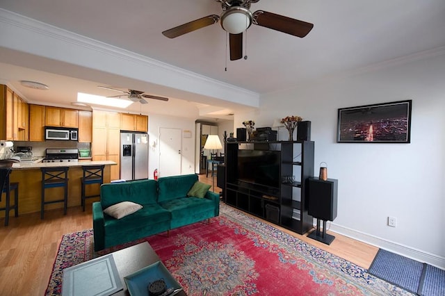 living room featuring crown molding and light wood-type flooring