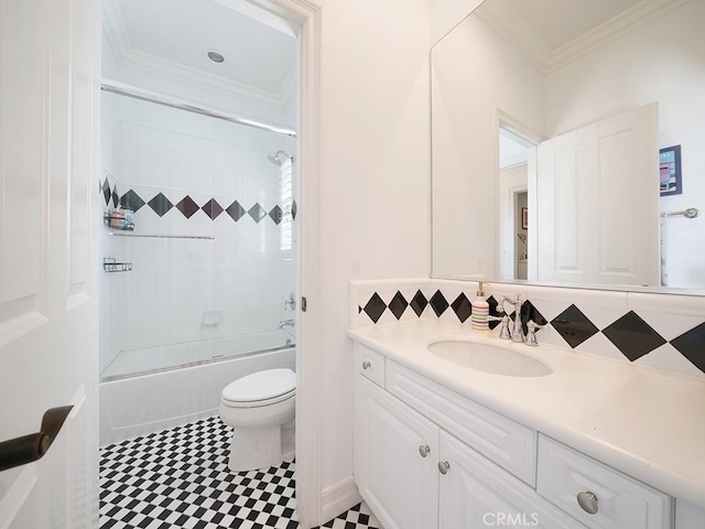 full bathroom with crown molding, toilet, vanity, and bath / shower combo with glass door